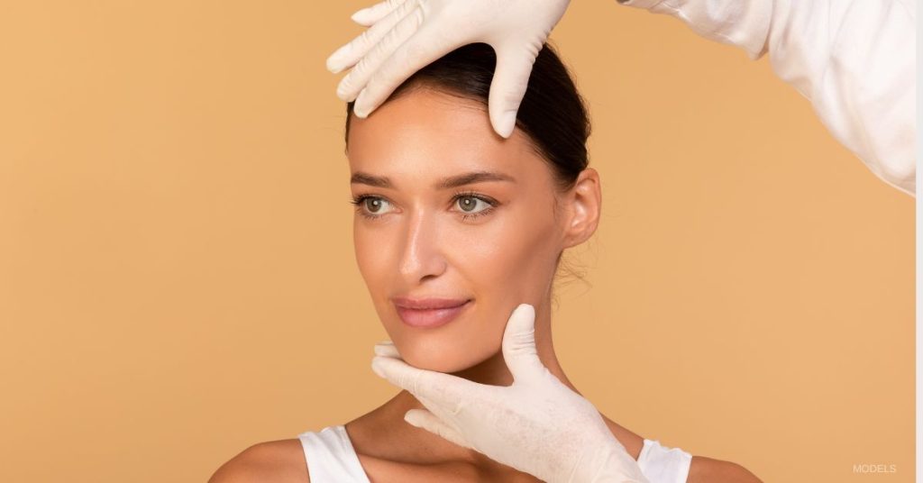 Woman with glowing skin is being examined for a facelift. (Model)